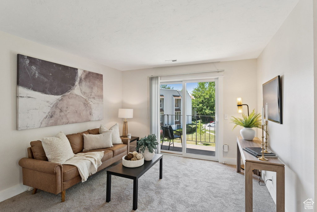 Carpeted living room featuring baseboards