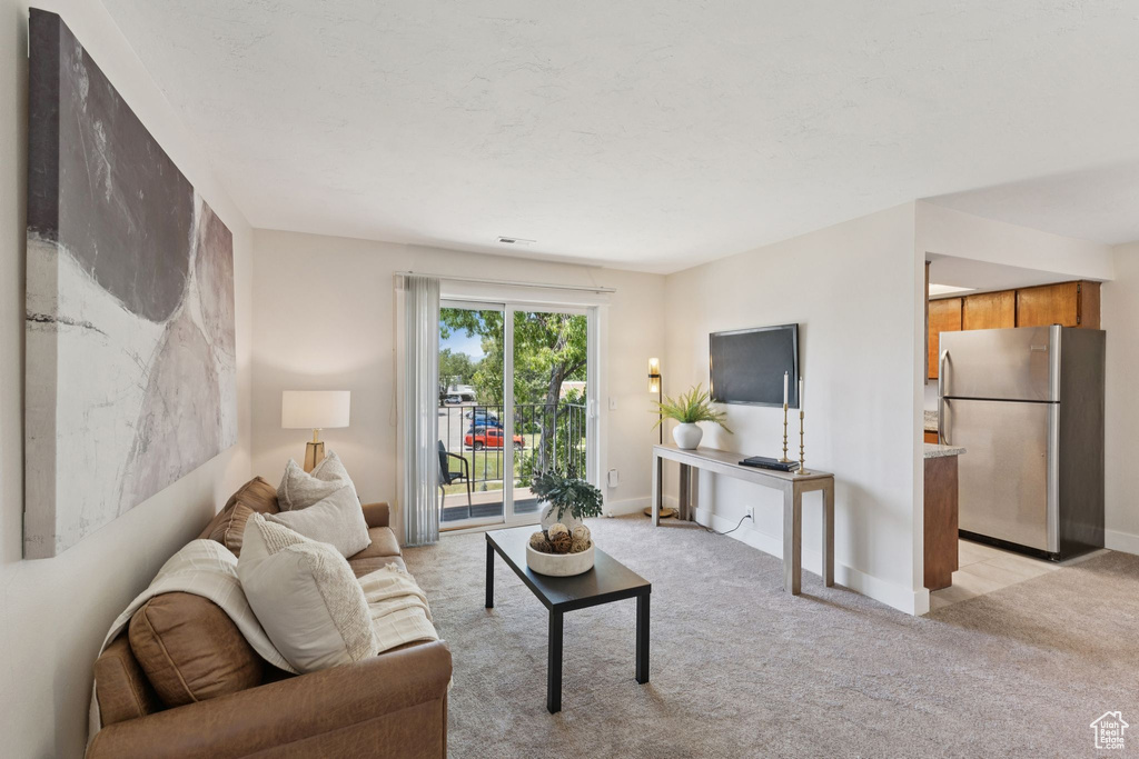 Living room with light colored carpet and baseboards