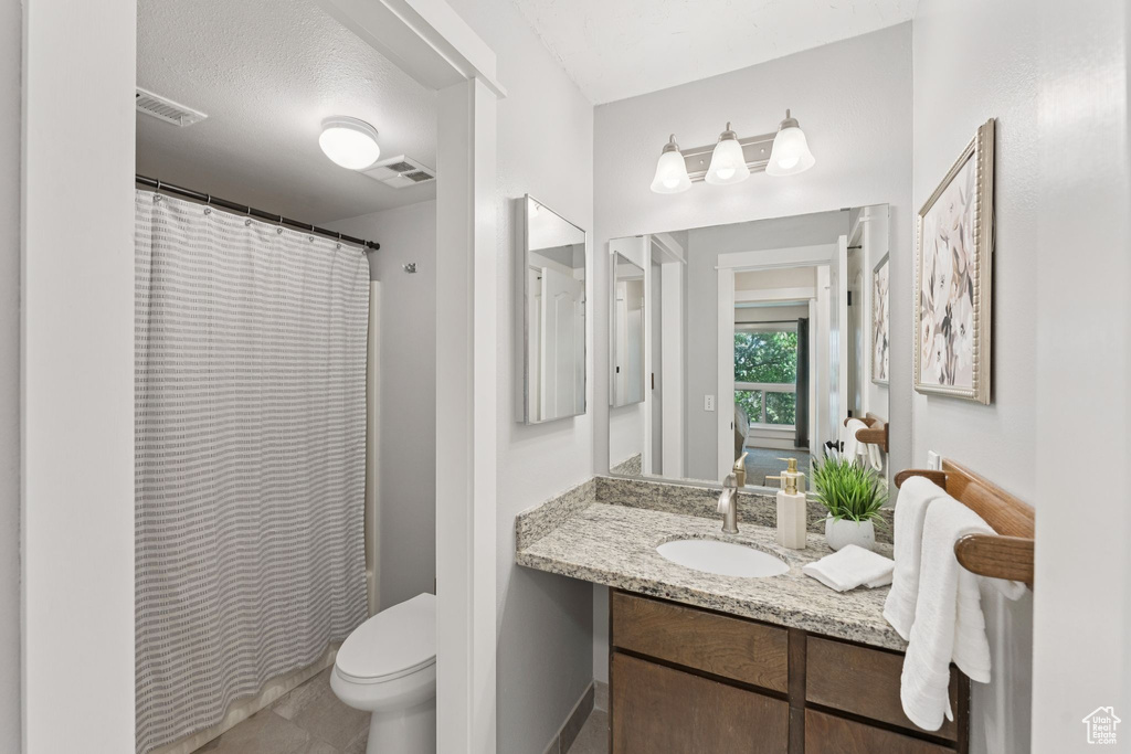 Bathroom featuring vanity and a shower with shower curtain
