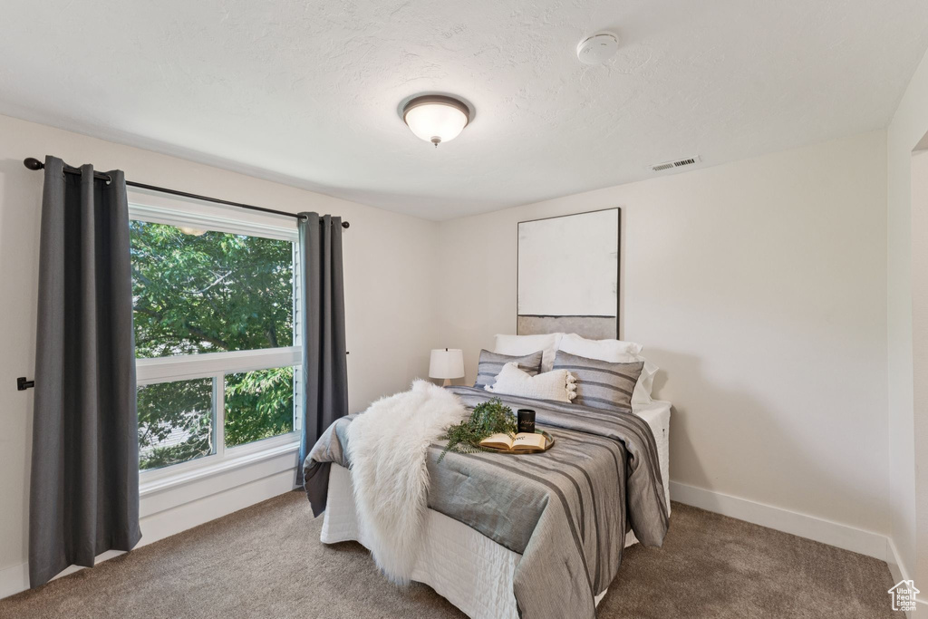 Carpeted bedroom featuring baseboards