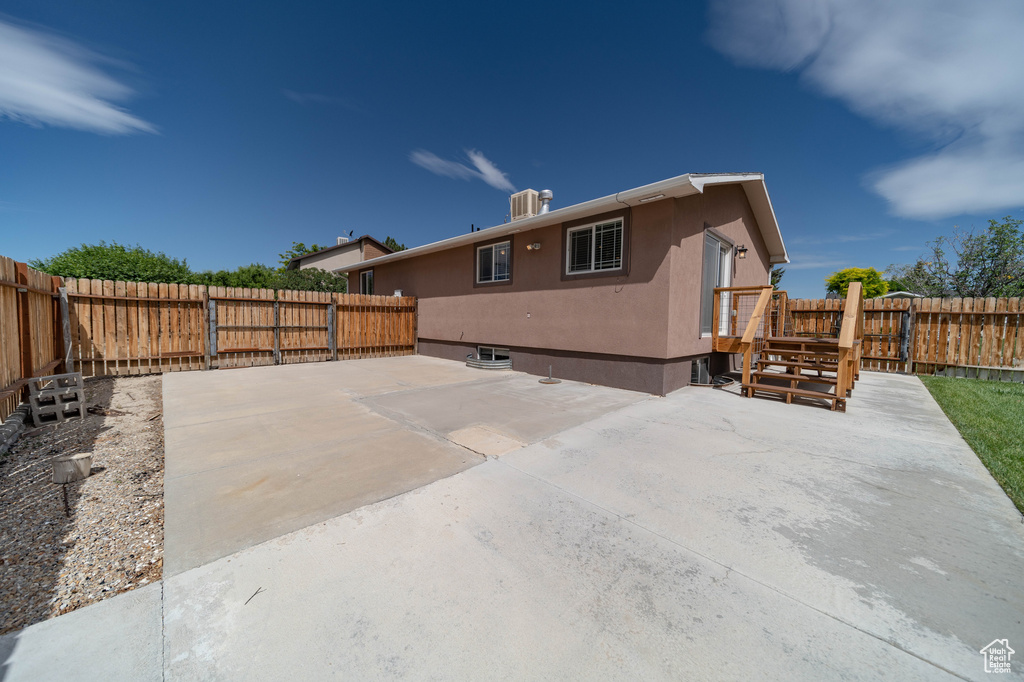 Back of house with a patio, a fenced backyard, and stucco siding