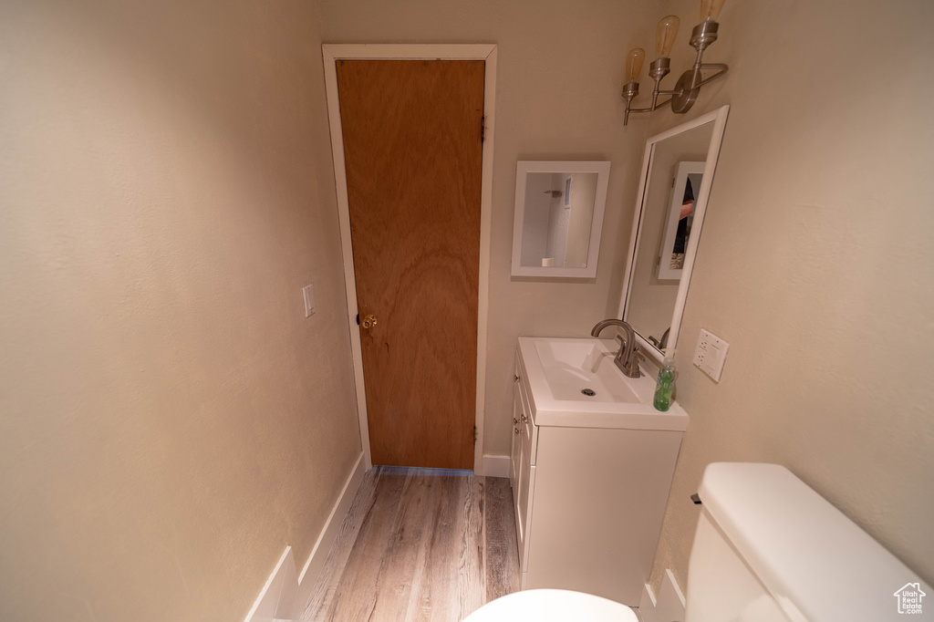 Bathroom featuring vanity and wood finished floors