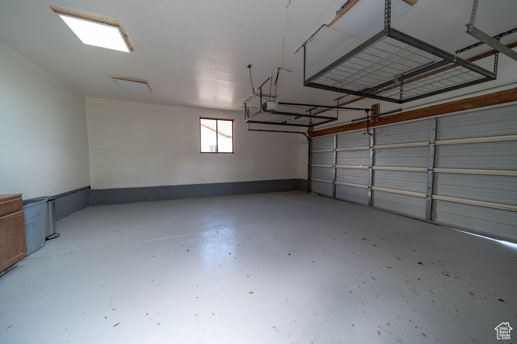 Garage featuring a garage door opener