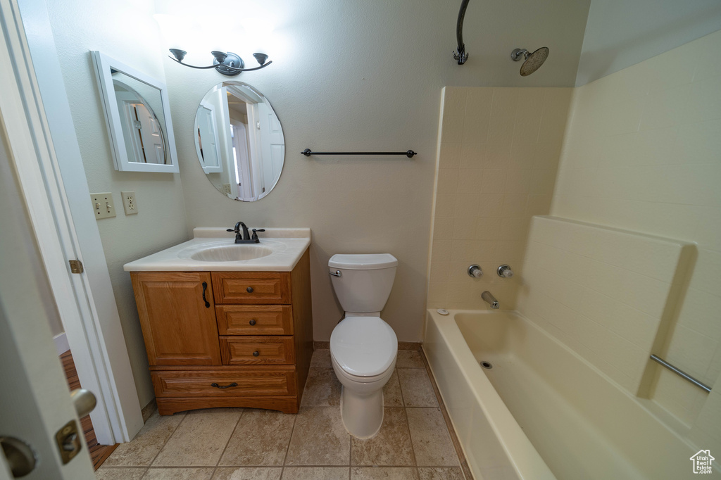 Full bathroom with vanity, shower / bath combination, and tile patterned floors