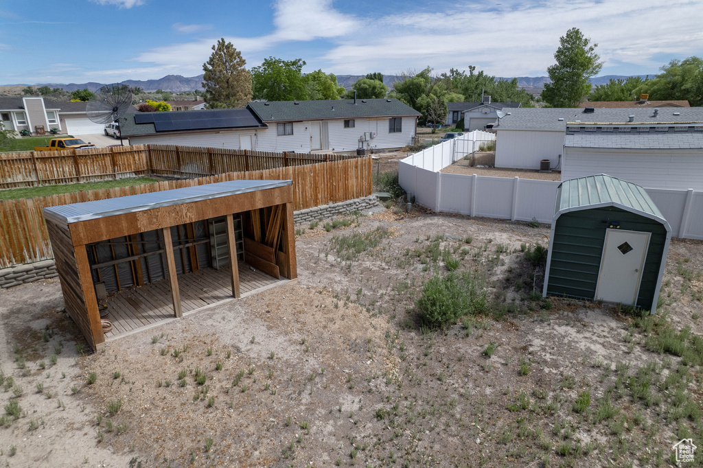 View of yard featuring an outbuilding, a residential view, and a mountain view