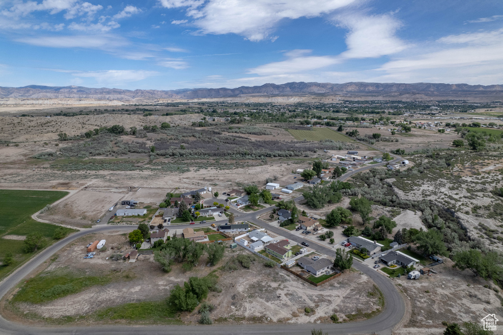 Aerial overview of property's location with a mountain backdrop and a desert landscape