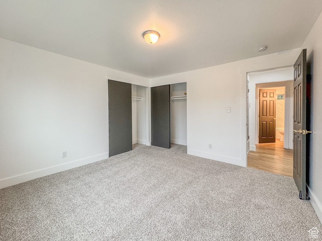 Unfurnished bedroom with carpet and baseboards