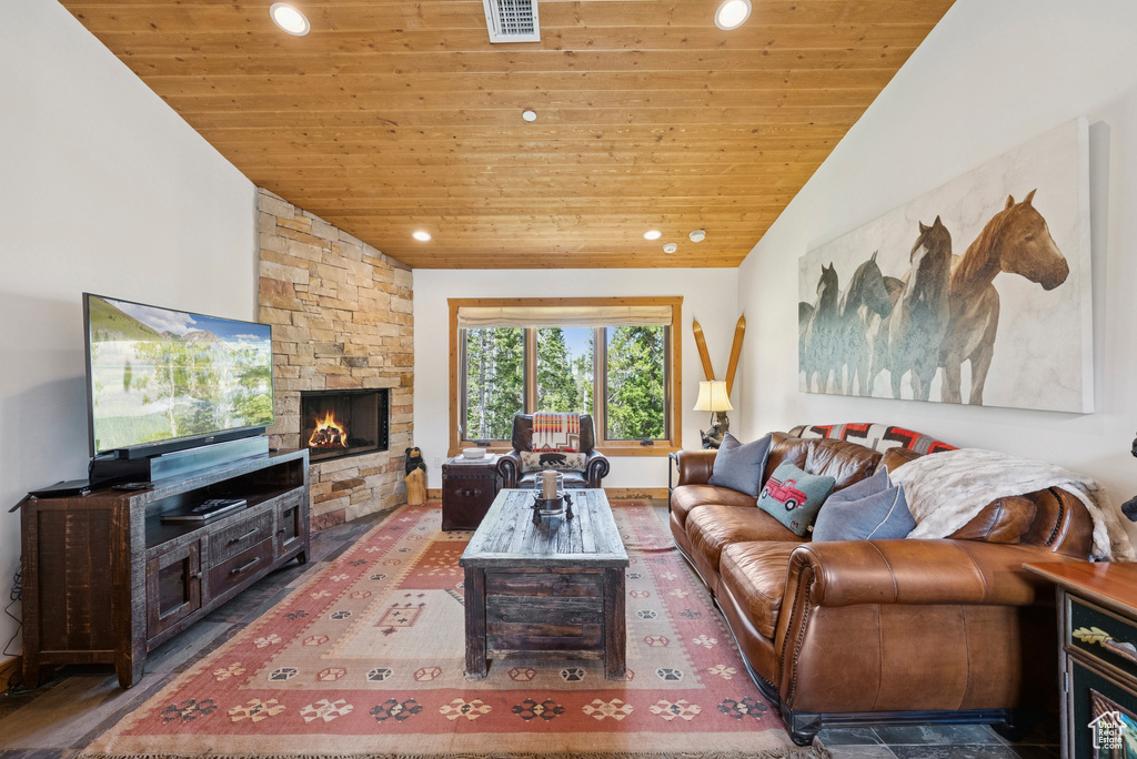 Living area with wood ceiling, recessed lighting, a fireplace, and vaulted ceiling