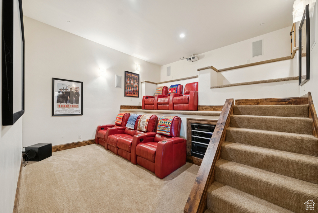 Carpeted home theater featuring baseboards