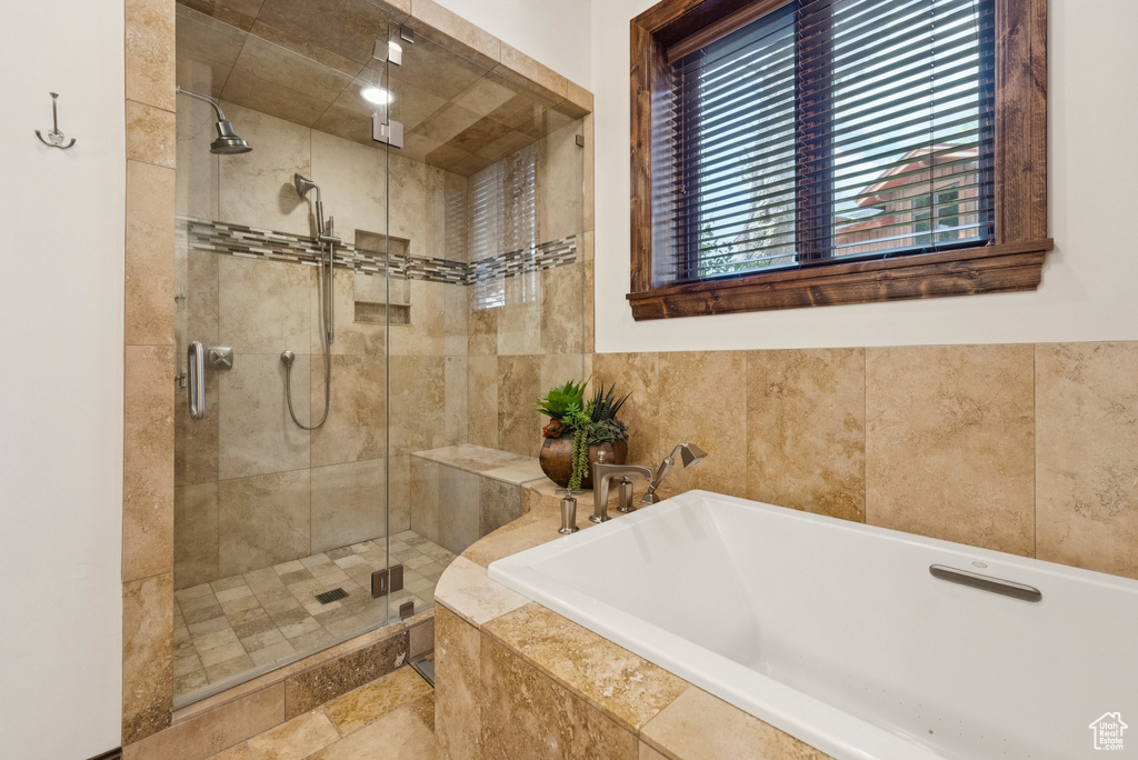 Bathroom with a bath and a stall shower