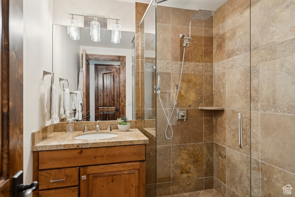 Full bath featuring vanity and a shower stall
