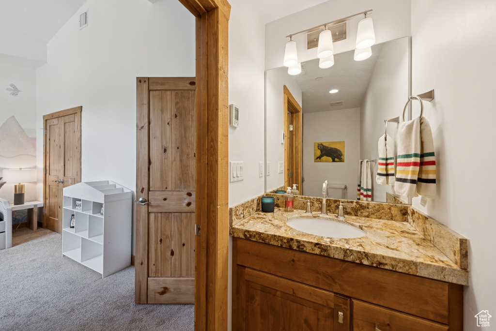 Bathroom featuring vanity and a towering ceiling
