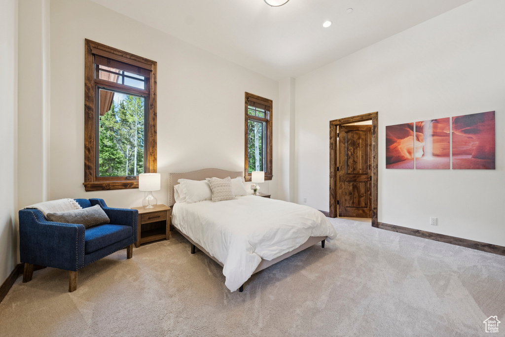 Bedroom featuring light colored carpet and baseboards
