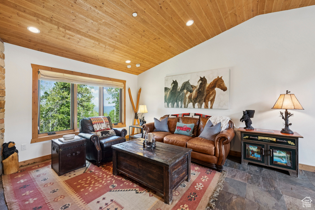 Living room with wood ceiling, lofted ceiling, recessed lighting, and stone finish floors
