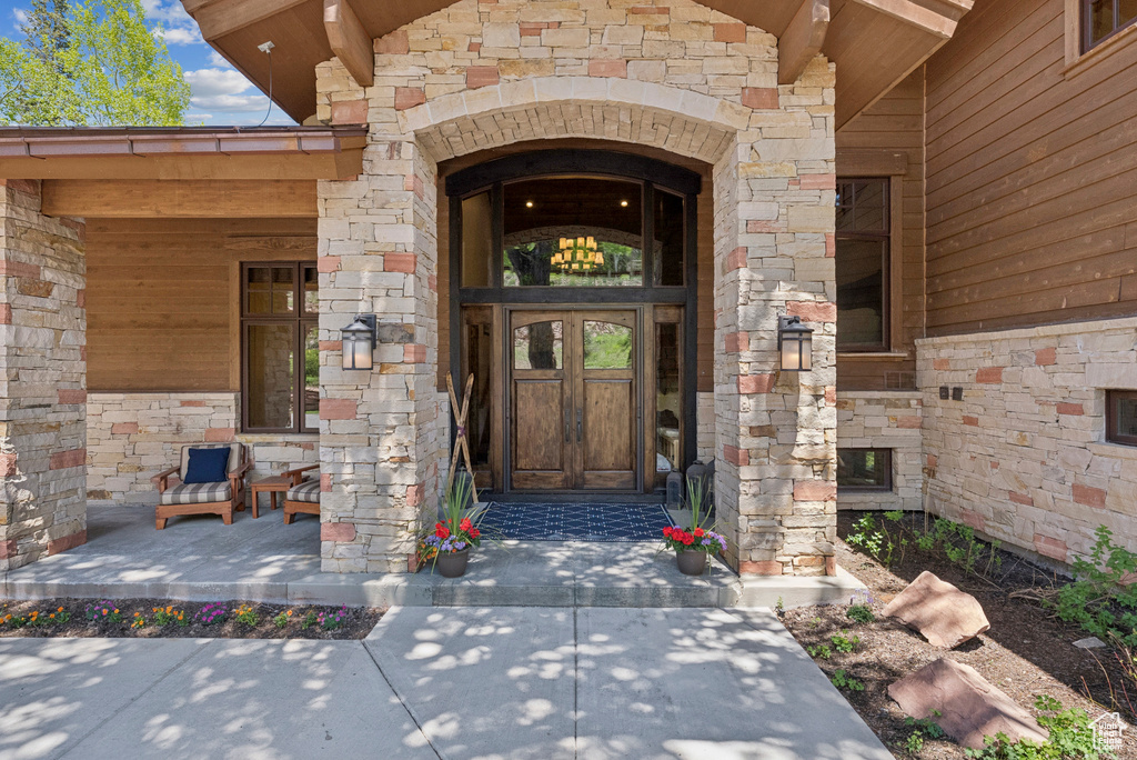 Doorway to property featuring stone siding