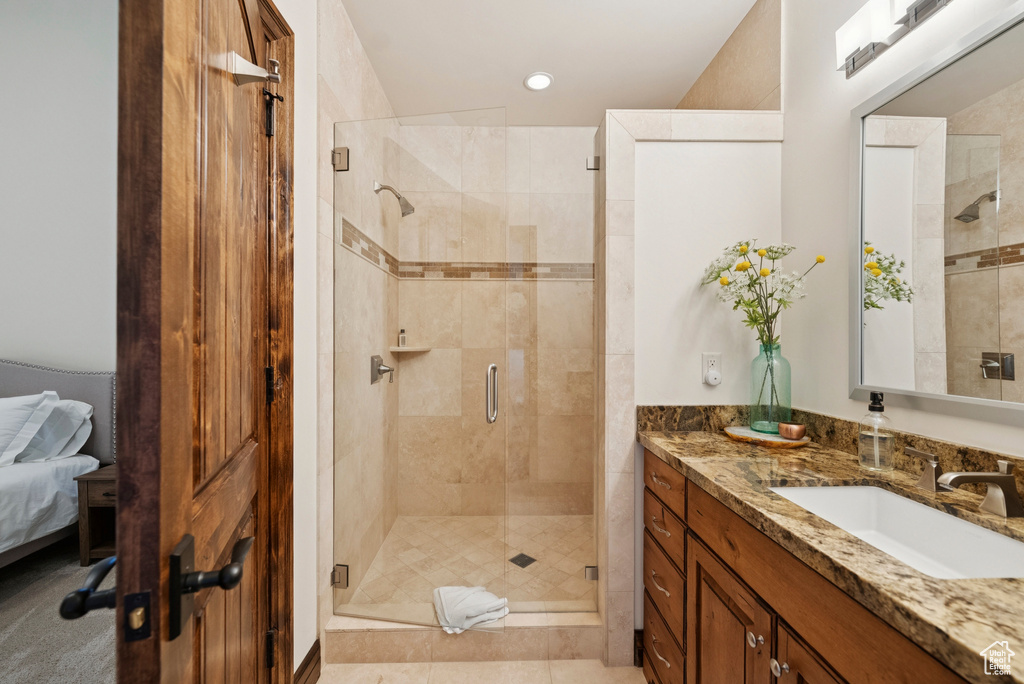 Full bathroom with vanity, a stall shower, recessed lighting, and ensuite bathroom