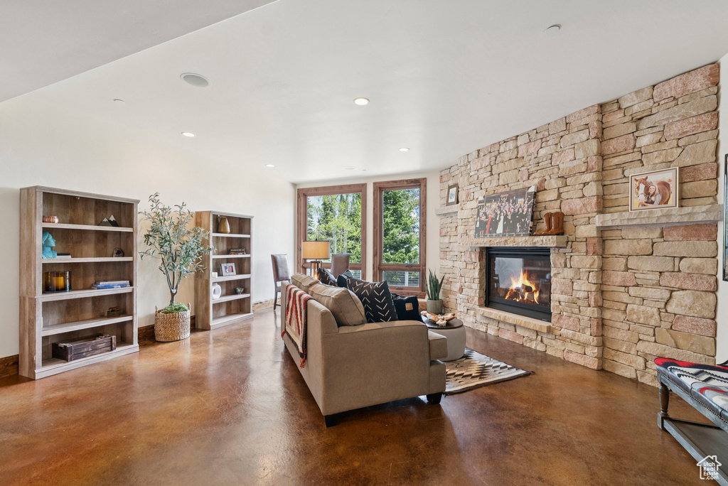 Living area featuring finished concrete floors, a fireplace, and recessed lighting