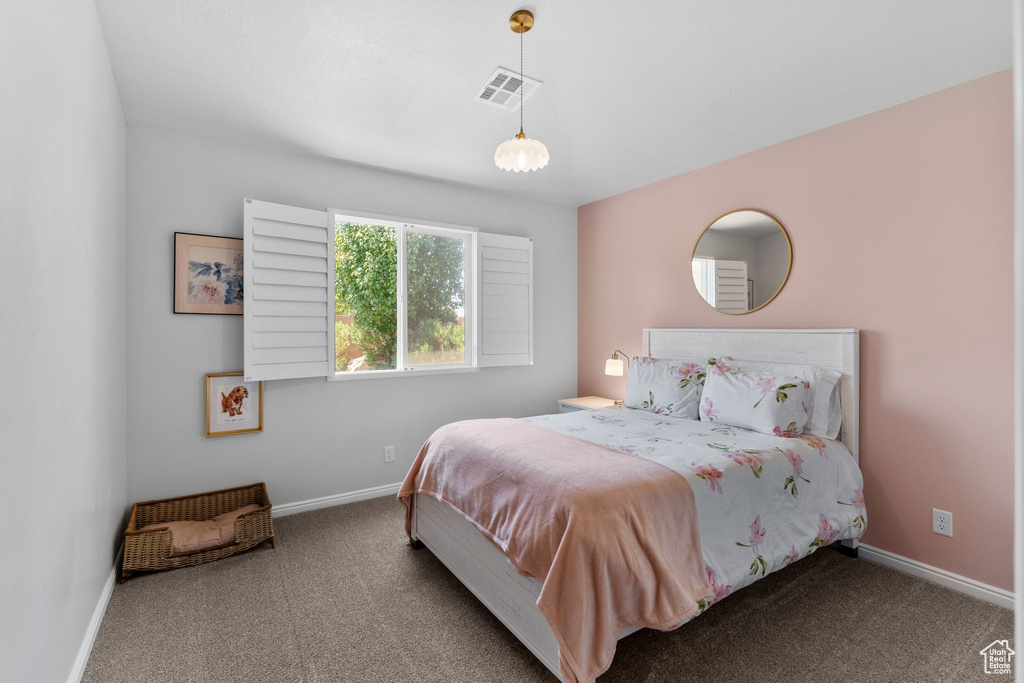 Carpeted bedroom featuring baseboards
