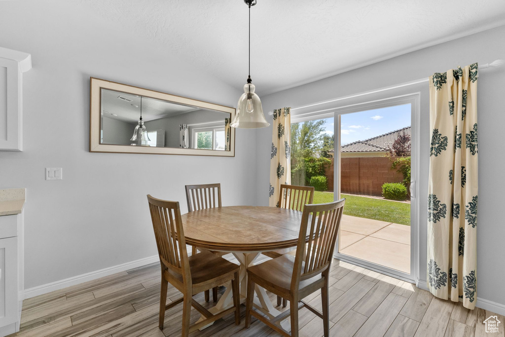 Dining space featuring light wood-type flooring and baseboards