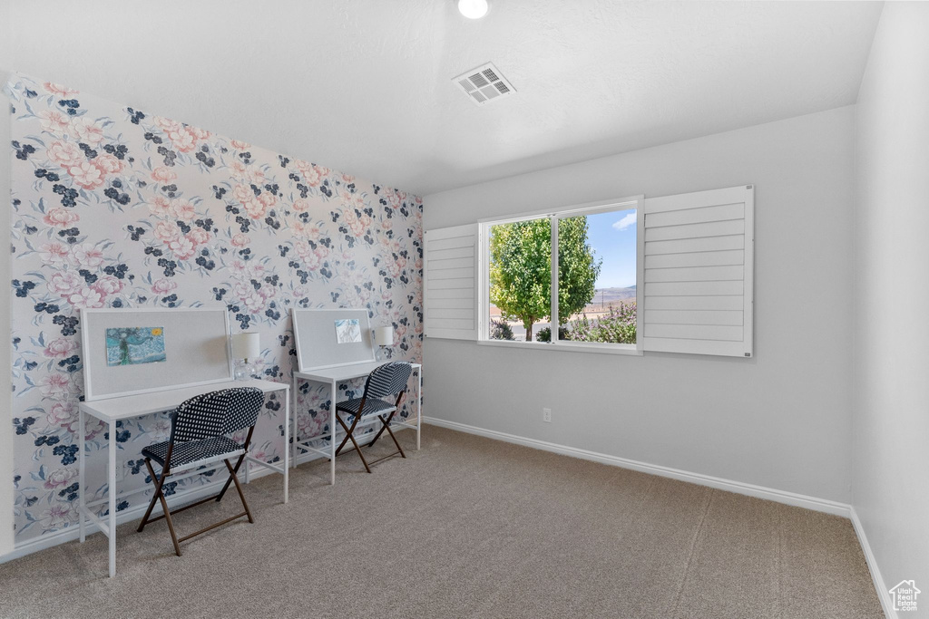 Office with carpet flooring and wallpapered walls