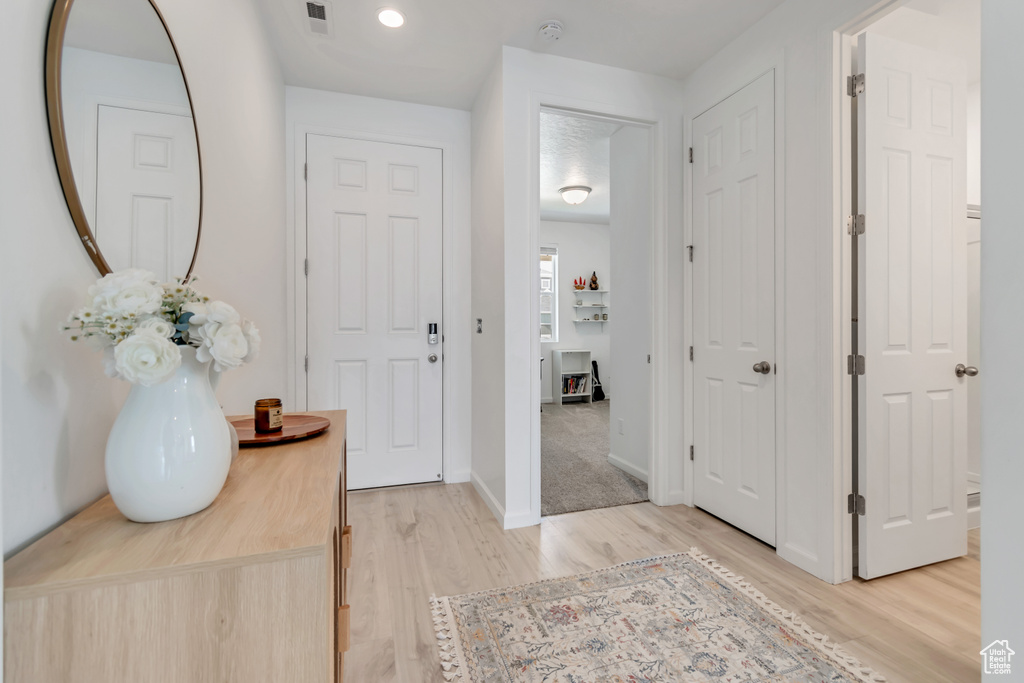 Entrance foyer featuring light wood finished floors and baseboards