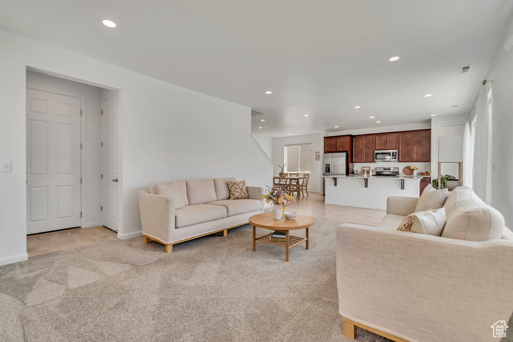 Living room featuring recessed lighting and light colored carpet