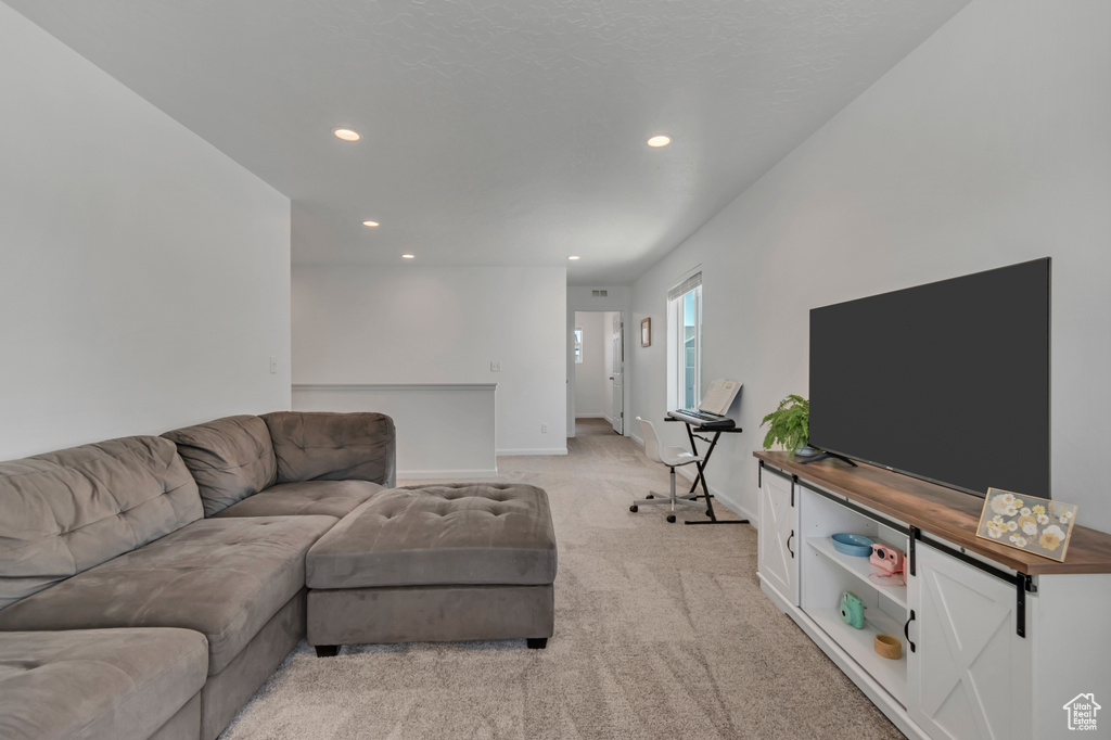 Living room with recessed lighting and light carpet