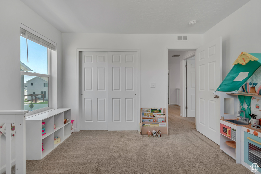 Recreation room with carpet flooring
