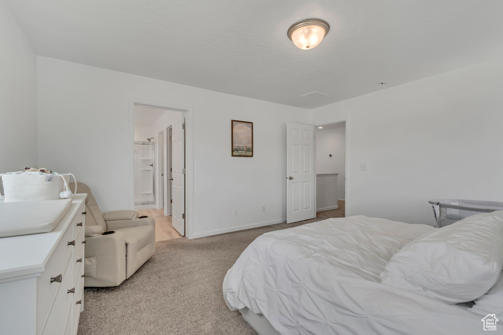 Bedroom with light colored carpet and baseboards
