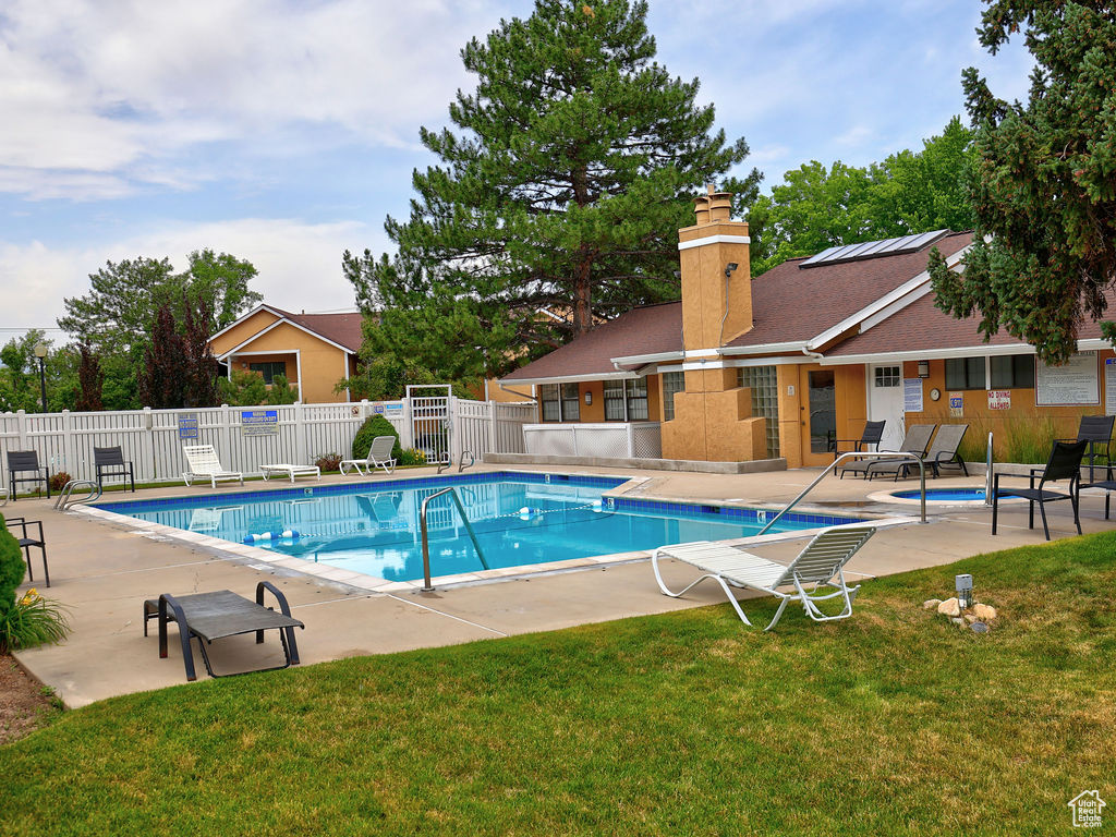 Community pool with a patio