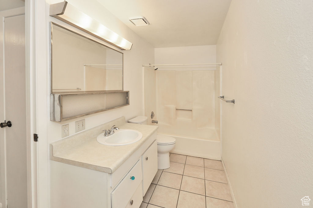 Bathroom with tile patterned floors, vanity, and shower / bath combination