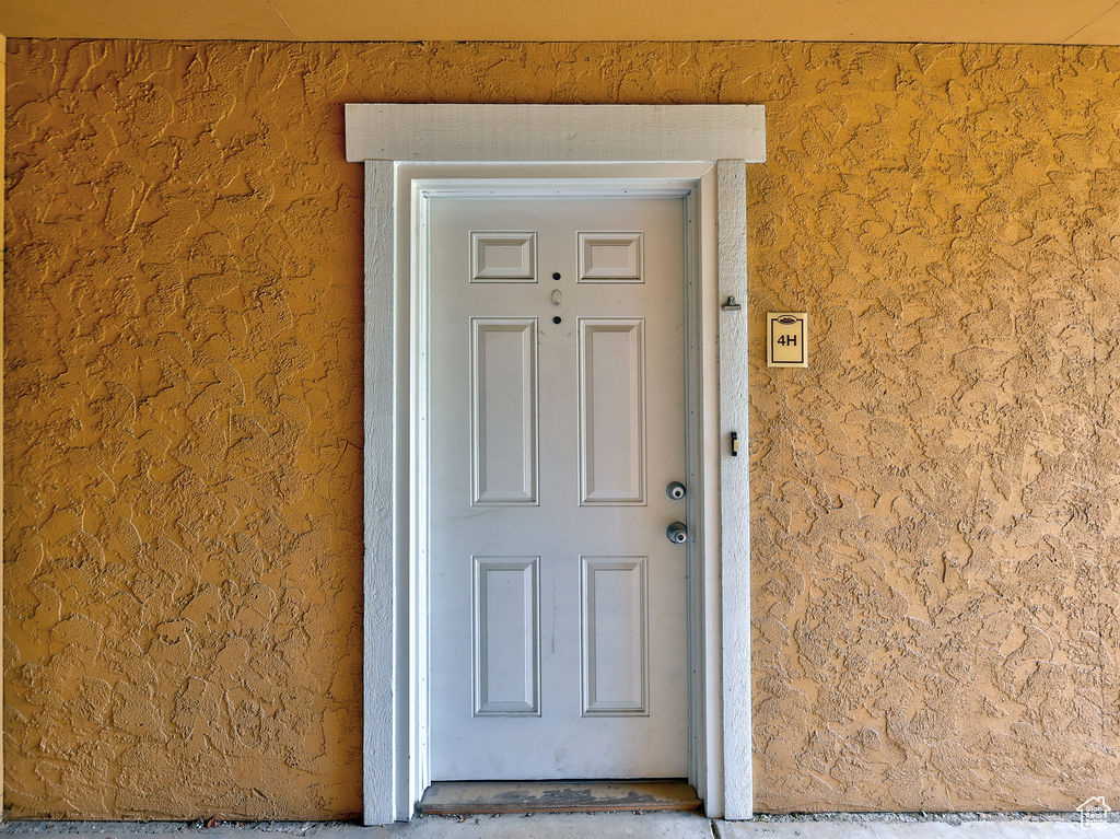 Entrance to property featuring stucco siding