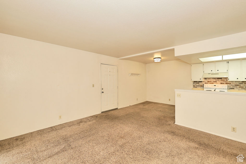 Unfurnished living room with light colored carpet