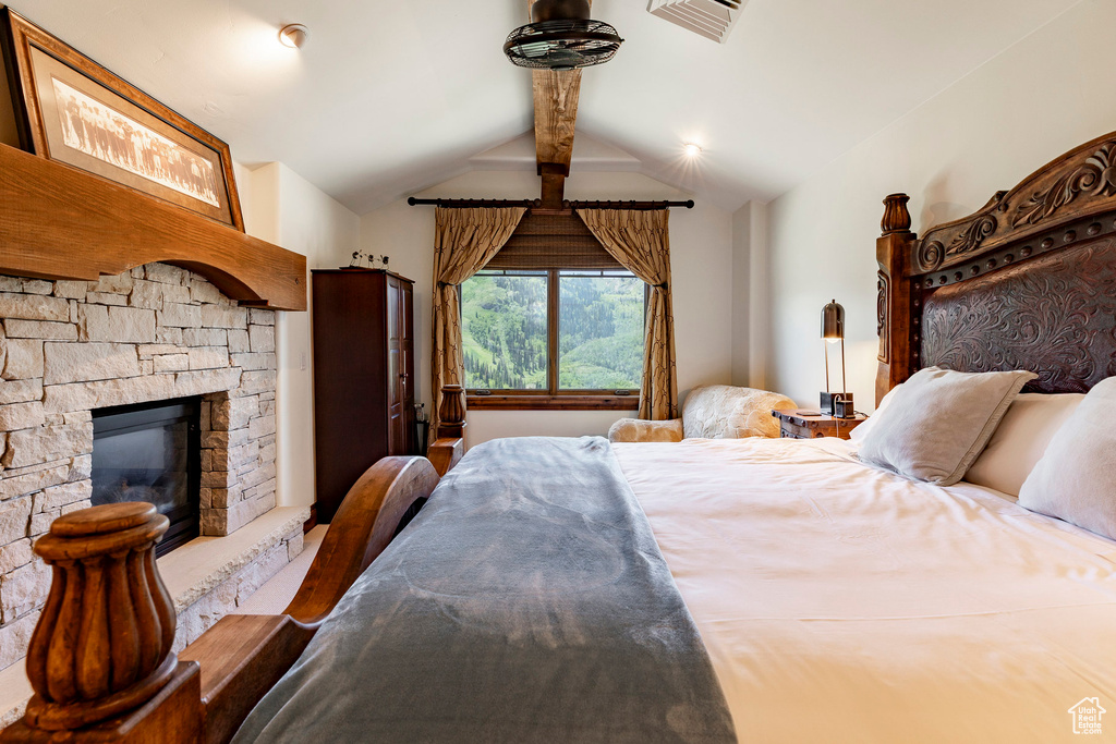 Bedroom with a stone fireplace
