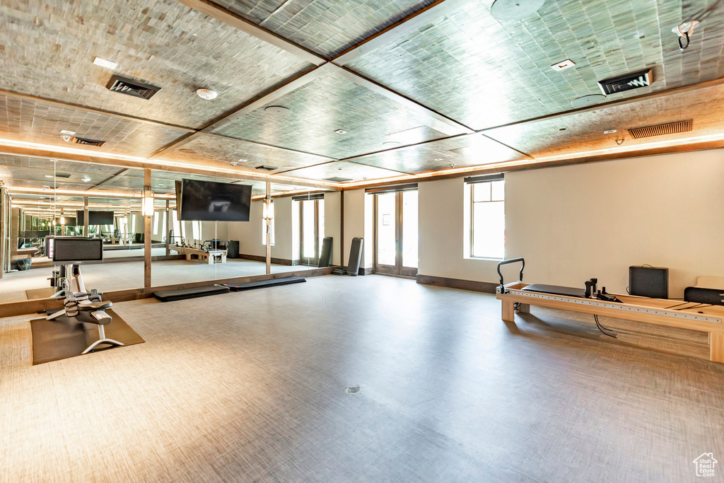 Workout area featuring baseboards and carpet