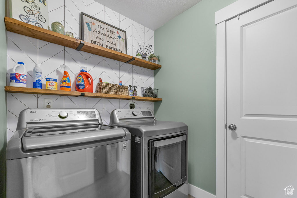 Laundry room featuring separate washer and dryer and baseboards