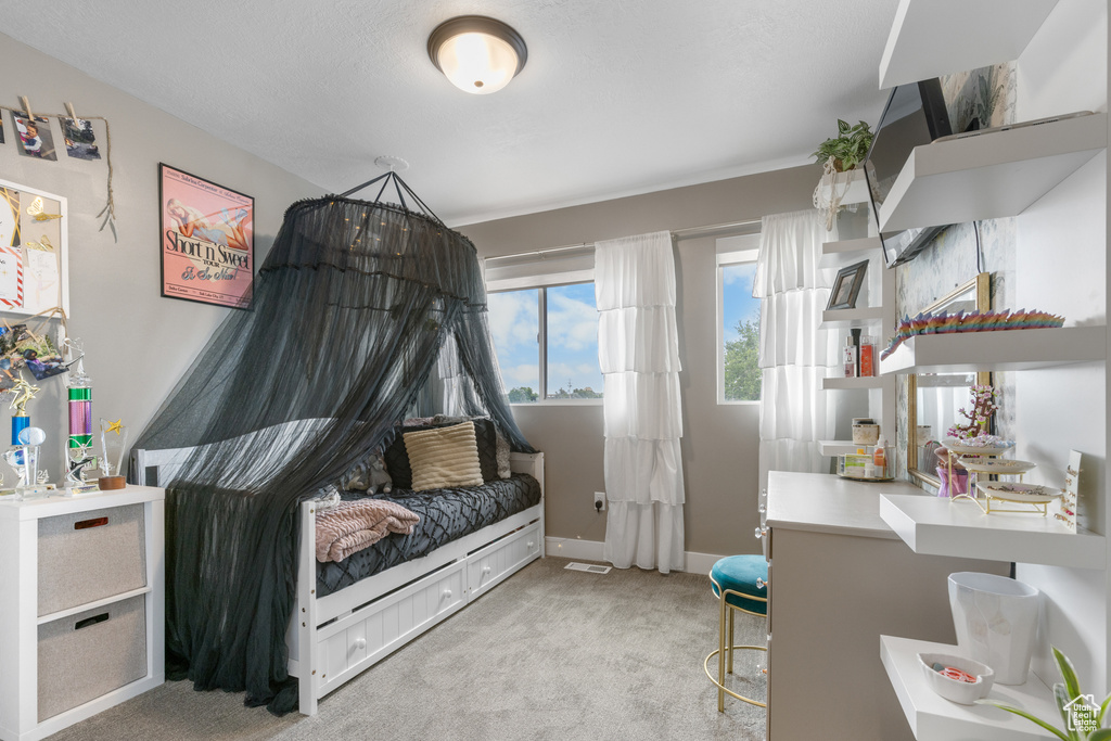 Bedroom featuring light colored carpet and baseboards