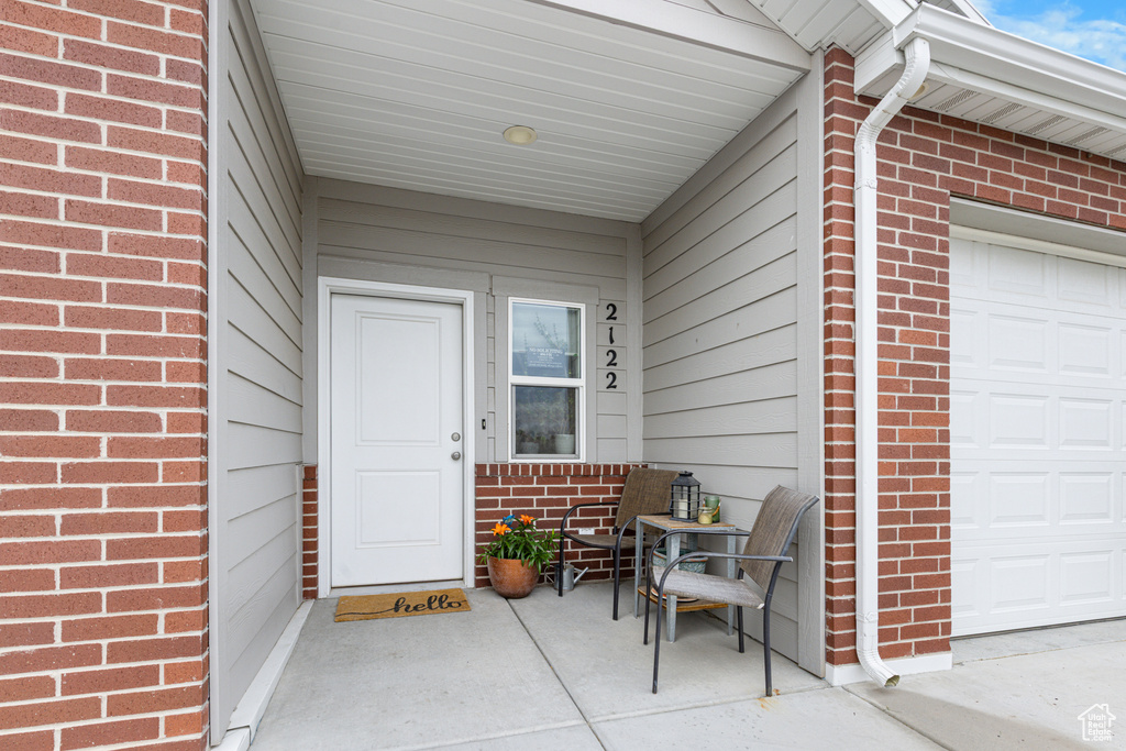 Property entrance featuring brick siding