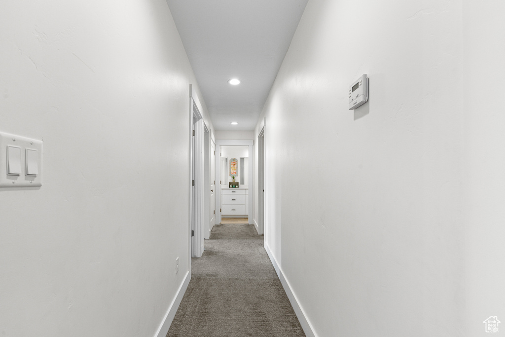 Corridor with carpet floors and recessed lighting