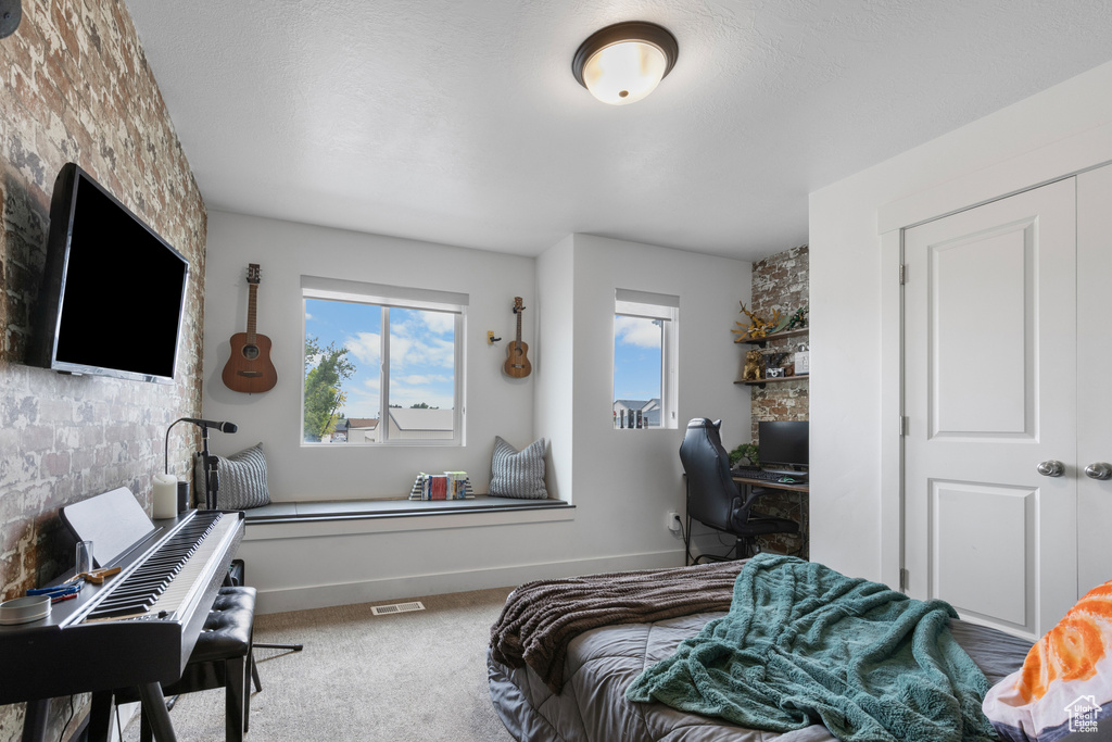 Bedroom with a desk and carpet