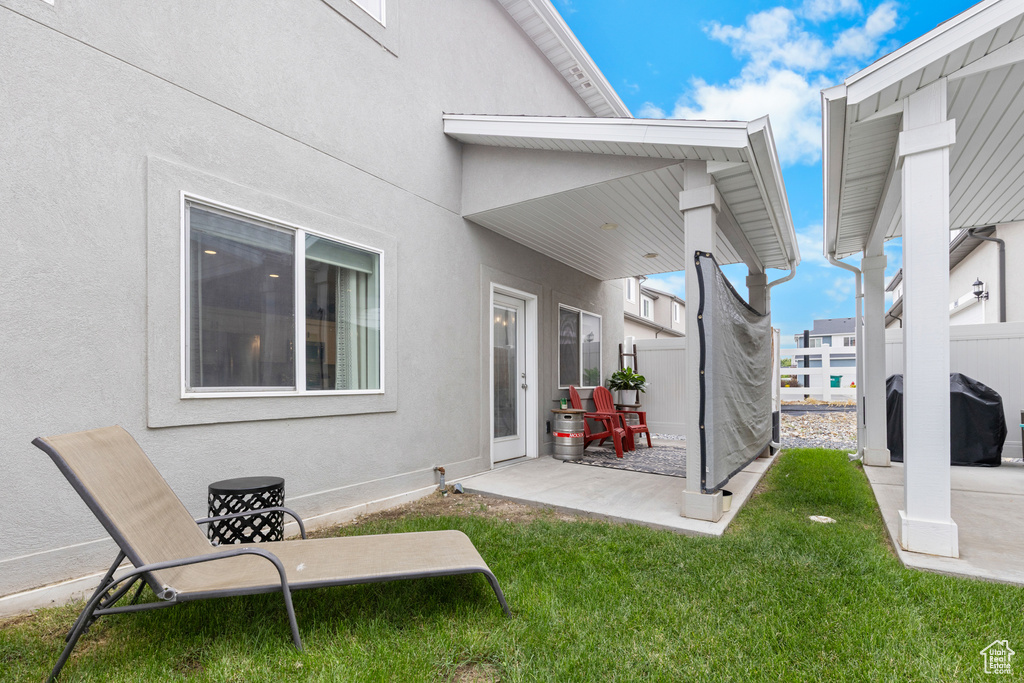 Rear view of house featuring a patio and stucco siding