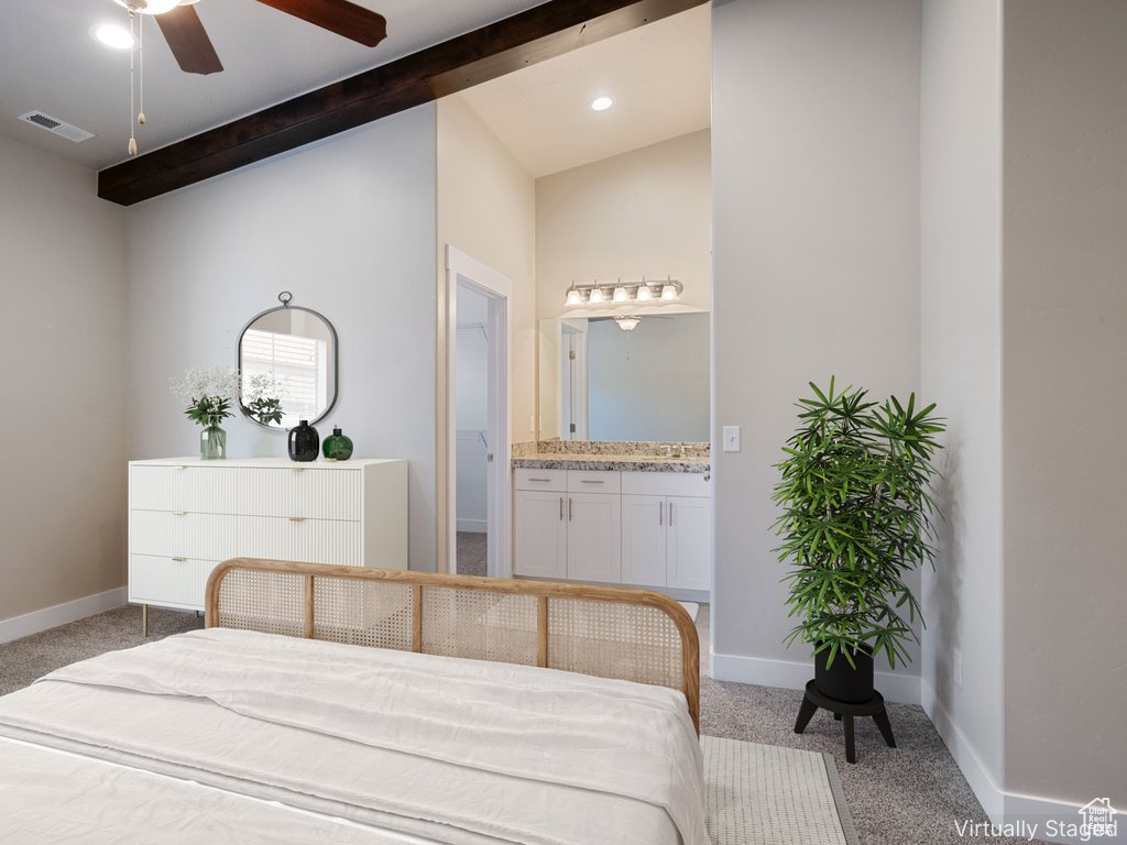 Bedroom with carpet and connected bathroom