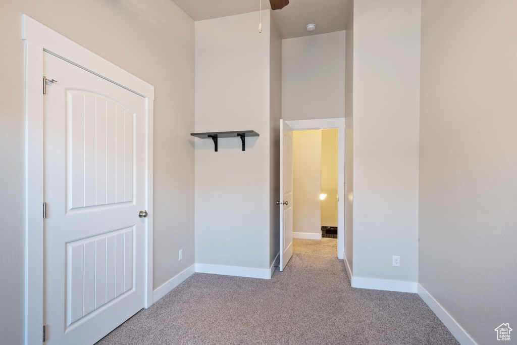 Unfurnished bedroom featuring light colored carpet and baseboards