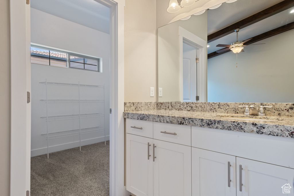 Bathroom with ceiling fan, vanity, and beamed ceiling