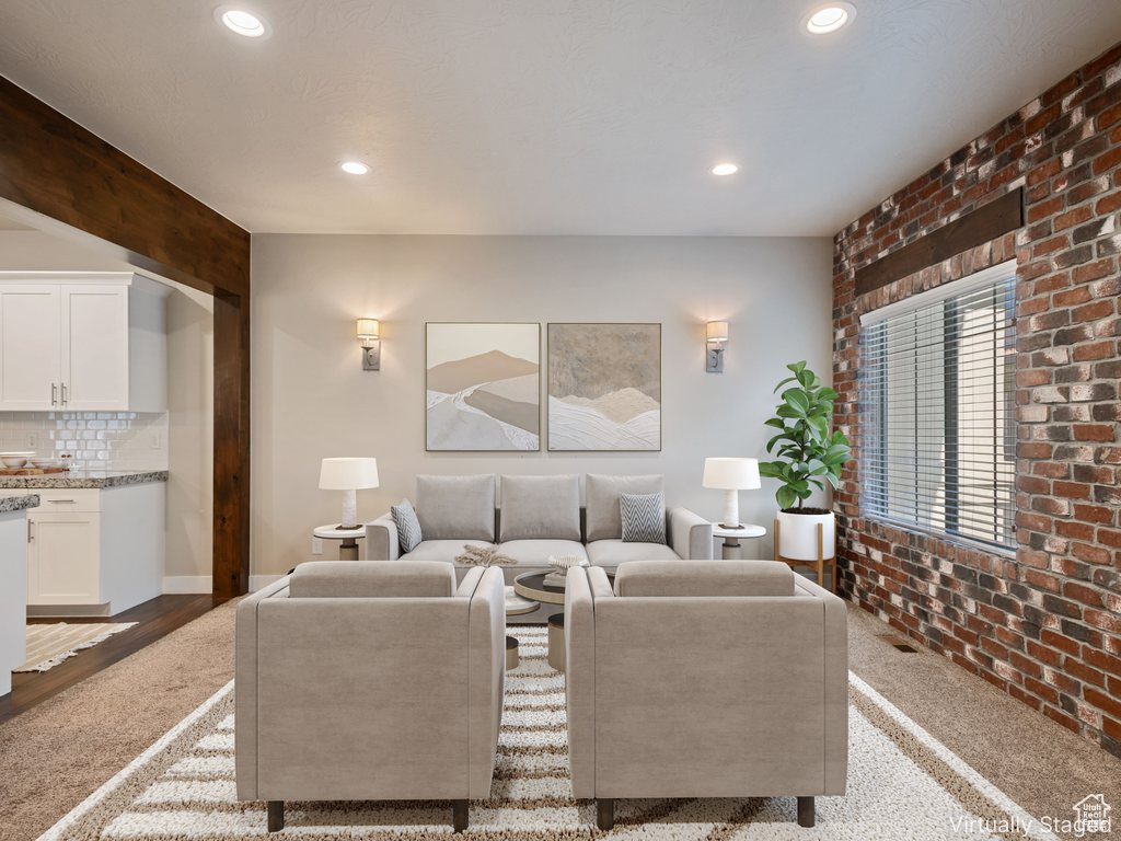 Living area with brick wall and recessed lighting