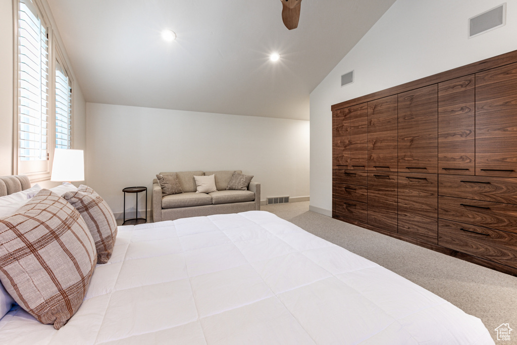 Carpeted bedroom with lofted ceiling, ceiling fan, and recessed lighting