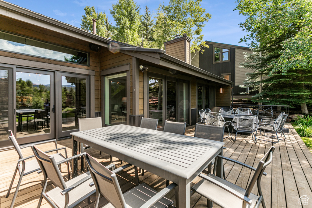 Wooden deck featuring outdoor dining space