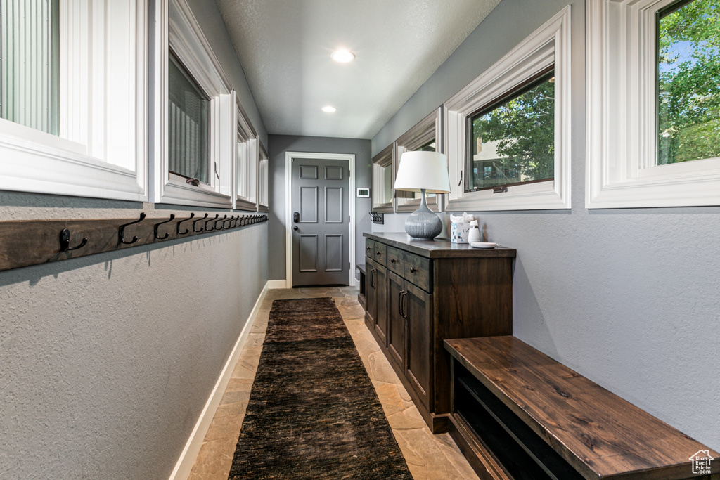 Doorway featuring a textured wall and recessed lighting