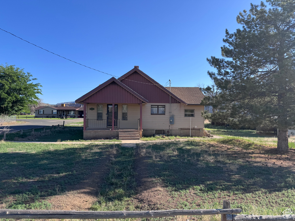 View of front of home featuring a porch and a front yard
