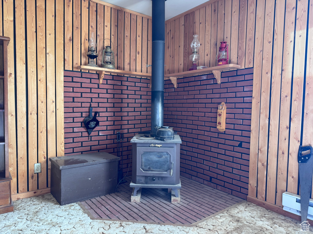 Detailed view of a wood stove, brick wall, and wood walls